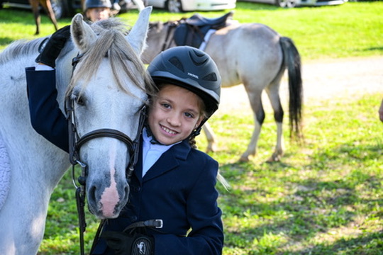 A young rider sharing a quiet moment with a pony